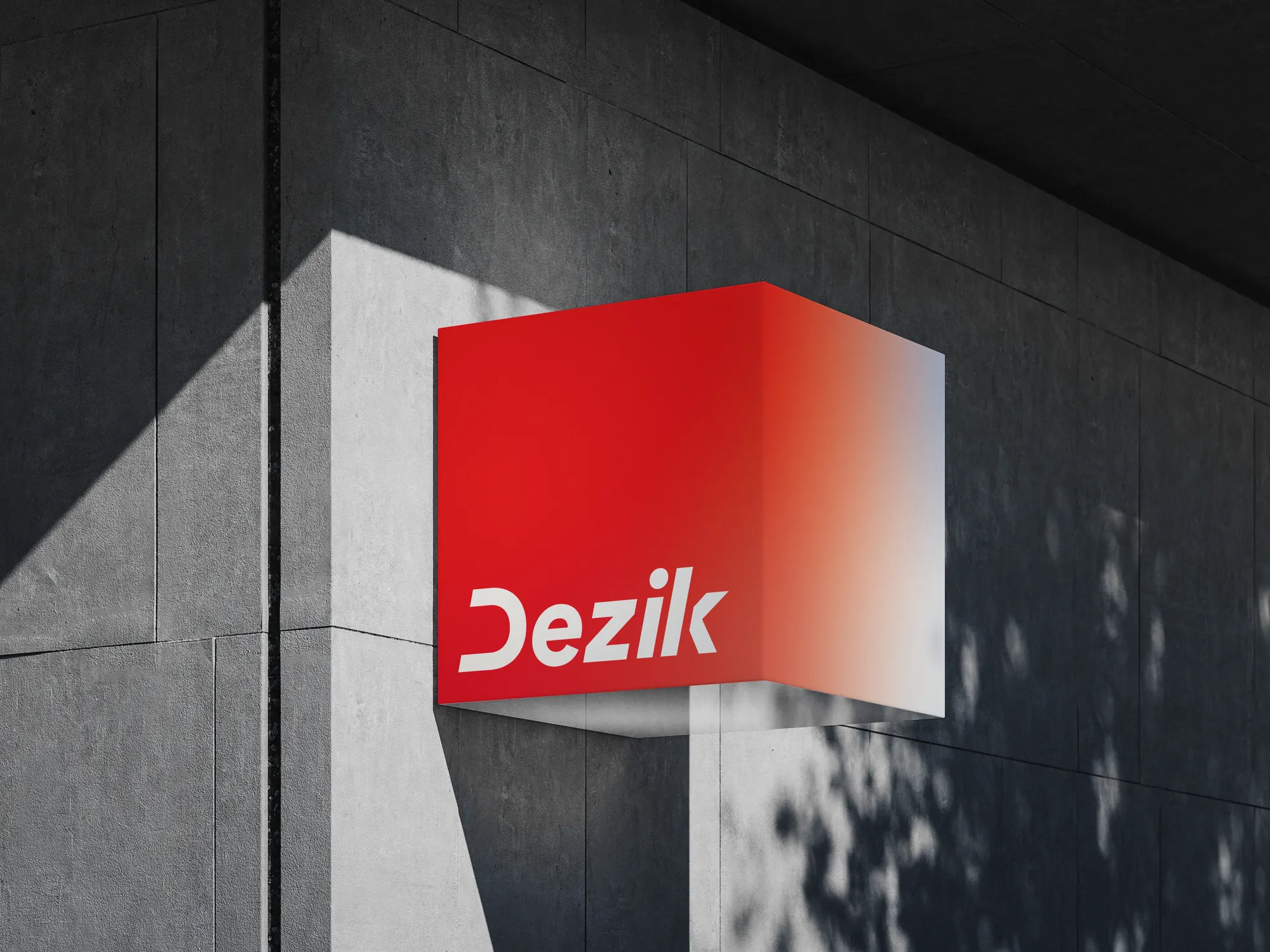 Rótulo exterior de Dezik Labs, wordmark en degradado de blanco a rojo montado en la fachada de un edificio