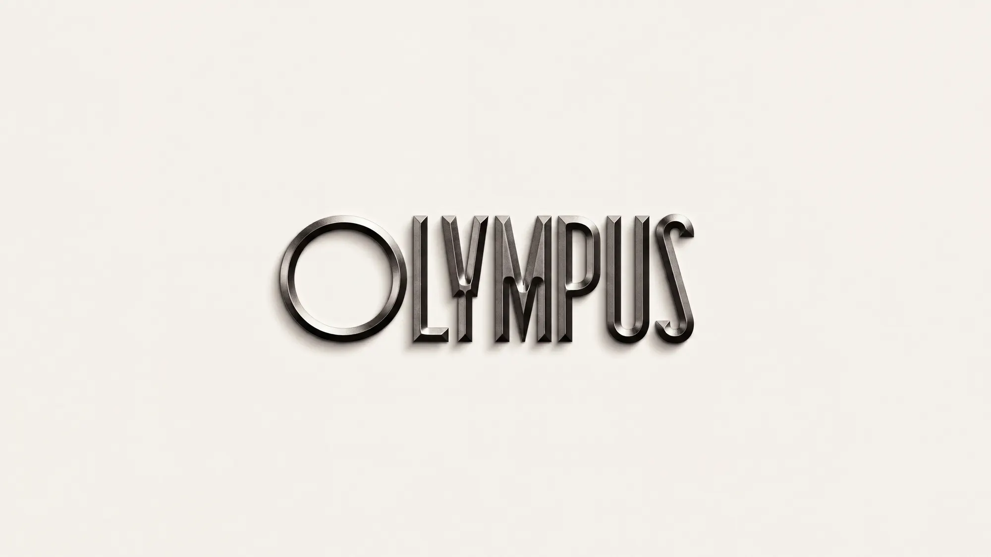 Wordmark de Olympus en relieve sobre una superficie color hueso
